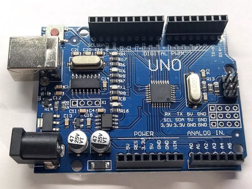 An Arduino Uno board on a workbench, a common starting point for classroom and student IoT projects.